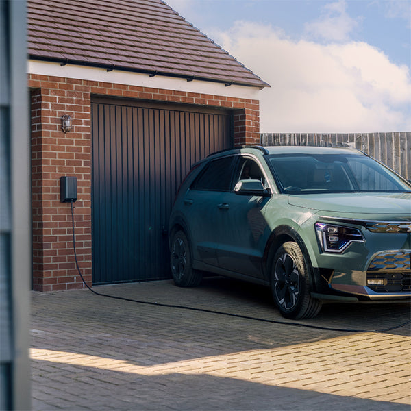 Andersen Quartz domestic home EV charger installed near an electric car