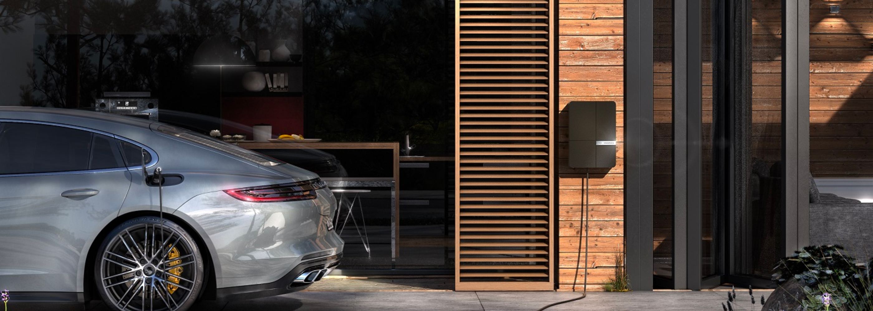 Andersen electric vehicle charger connected to car outside garage